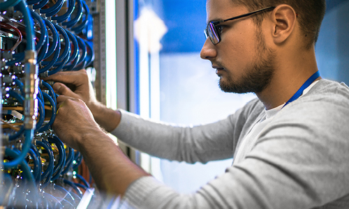 Student working on network switch and cables