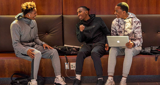 Three students hanging out together on an FLCC campus lounge.