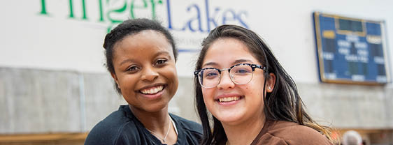 Two FLCC students laughing and enjoying themselves outside on FLCC's campus.