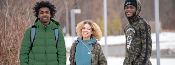 Four prospective students walking outside main campus, attending one-on-one Admissions Counselor appointments at FLCC.