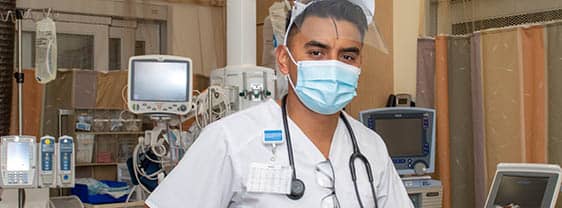 Nursing student in uniform prepped for working with patient.