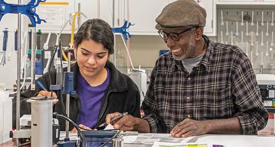 Two FLCC viticulture students work together in the enology lab.