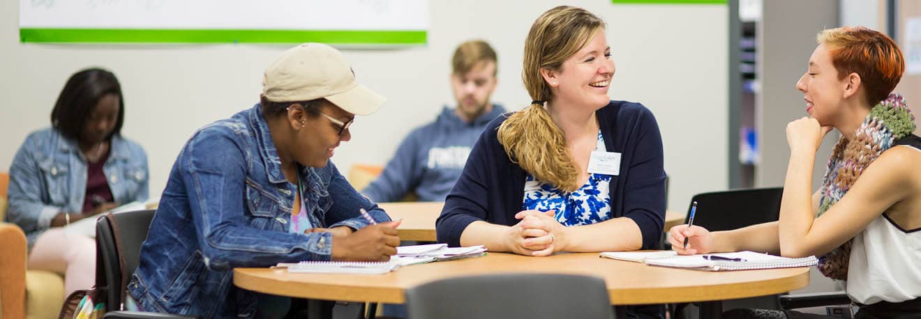  Staff member and students in the Academic Success and Access Programs center.