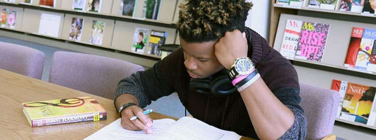 An undecided student studying in the library.