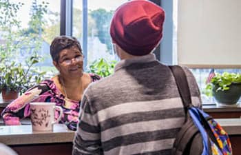 An undecided student speaking with a staff member about applying for college.